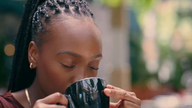 Face, smile and black woman drinking coffee for thinking in cafe restaurant. Happy person, espresso or dream in peace, vision or relax in shop to enjoy latte beverage cup for breakfast in the morning