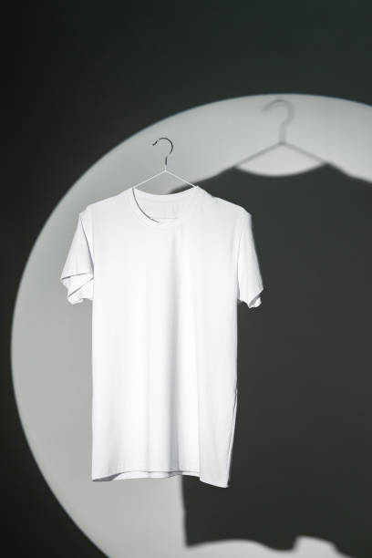 istock Blank T-shirt hanging in a spotlight in studio 1971951776