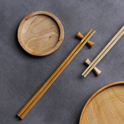 wooden chopsticks and coasters. wood roaster. wooden plate. photo flatlay