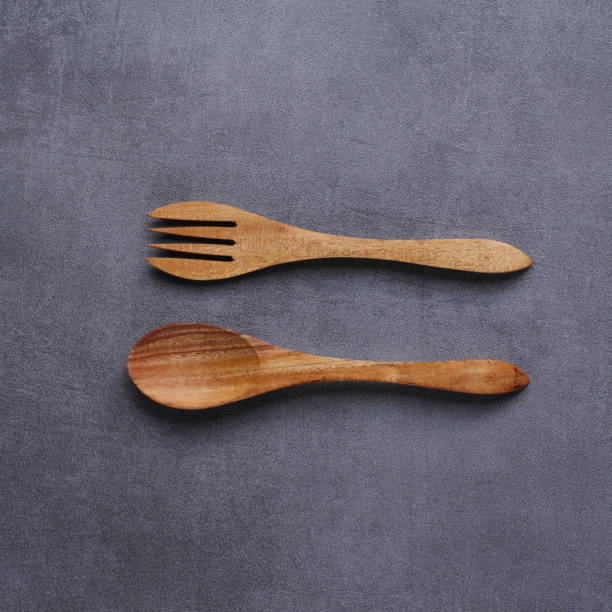 istock wooden spoon and fork with isolated background 1971958032