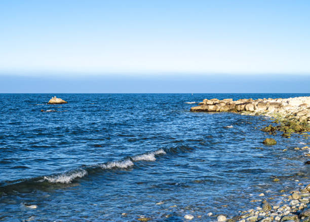 Views from a footpath in Falmouth, MA on Cape Cod of the coastline of Vineyard Sound.  Vineyard Sound is the stretch of the Atlantic Ocean which separates the Elizabethan Islands and the southwestern part of Cape Cod from the island of Martha's Vineyard.  The sound is enjoyed by boaters, fishermen and swimmers alike.