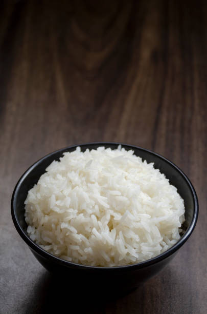 istock Rice in cup on wooden table wth copy space 1972002850