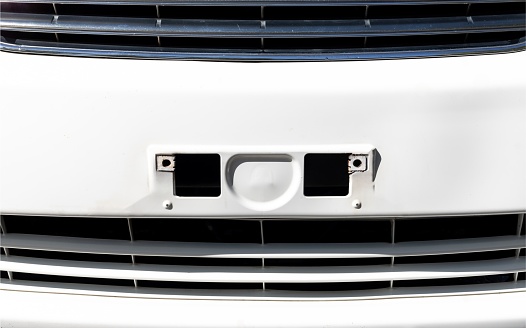 Front view of a car bumper with without number plate