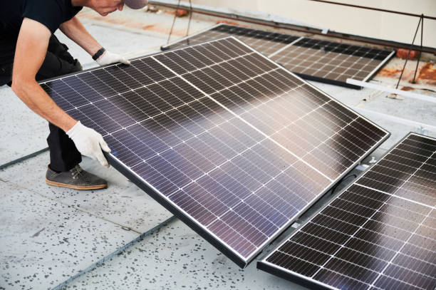istock Workers building solar panel system on roof of house. Men installing photovoltaic solar module 1972032122