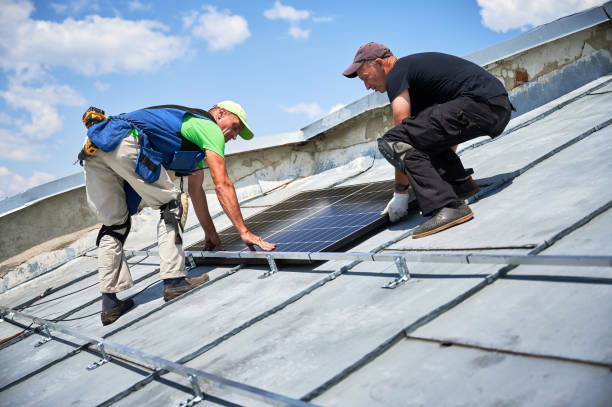 istock Workers building solar panel system on roof of house. Men installing photovoltaic solar module 1972032129