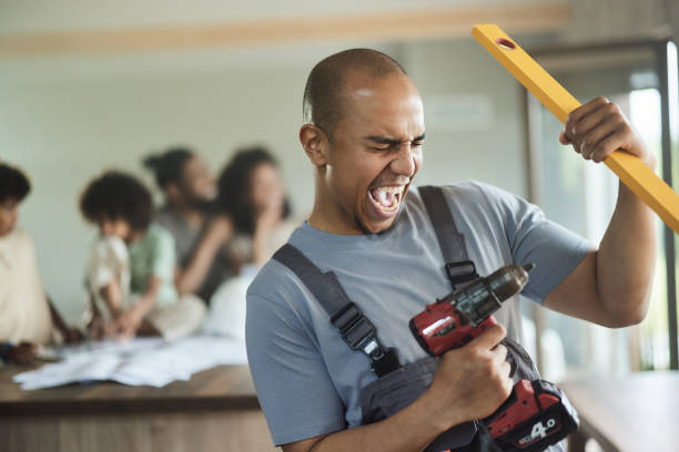 istock Cheerful male worker having fun during home renovation process. 1972042642