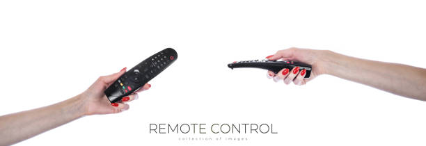 istock Hand holding audio and television remote control isolated on white background. Cliping Path. 1972050547
