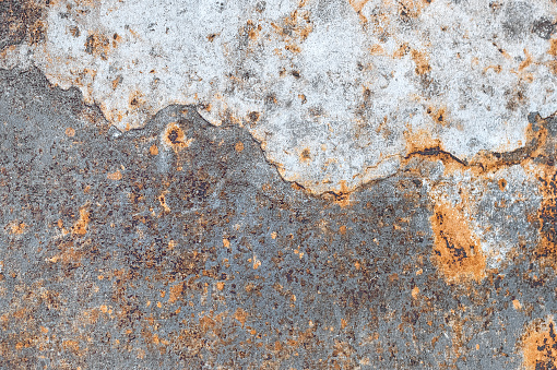 Texture of raised rust stains on the surface of a metal sheet.