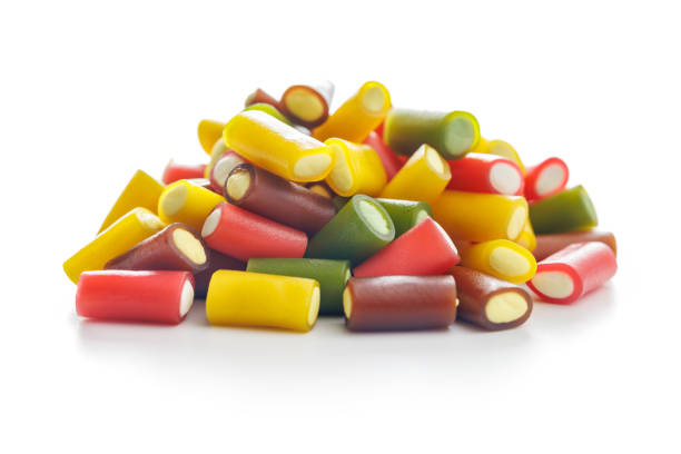 istock Sweet colorful chewy candy sticks isolated on white background. 1972104512
