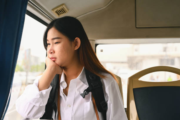 istock Young woman looking through looking through the window while commuting by bus 1972105060