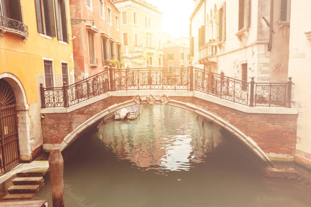 Narrow canal with a bridge in Venice city, Italy