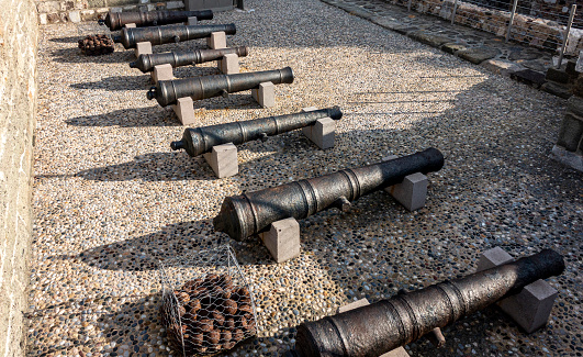 an antique cannon standing still.