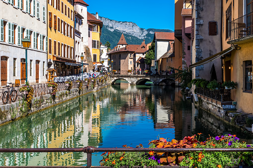 View of narrow canal among medieval houses in old town of Annecy, France.
