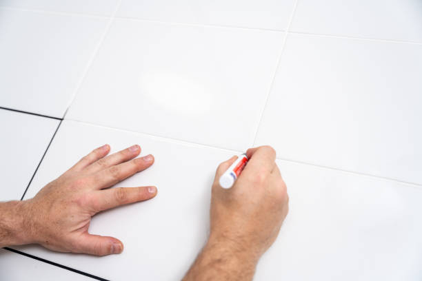 istock Painting grout on tile joints with a black acrylic marker 1972131772