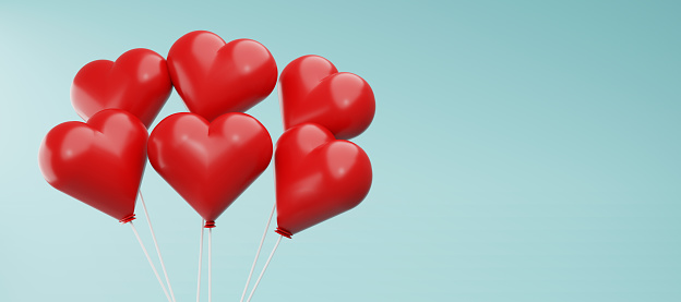 Heart shaped red balloons, on the blue background. Horizontal  banner, for romantic or Valentine`s Day  holiday decoration.Stock Photo