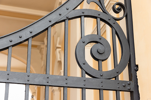 Vintage black forged gate details, close-up photo with selective focus, classic architecture template