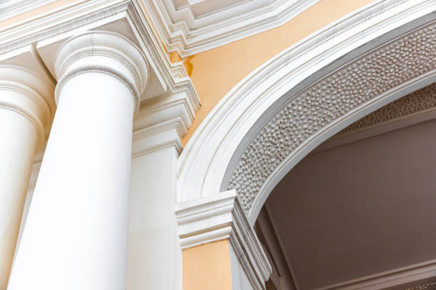 Classical portico details. White pillars and arched doorway