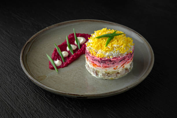 istock Herring salad in a ceramic plate on a dark textured background. Restaurant menu 1972245487