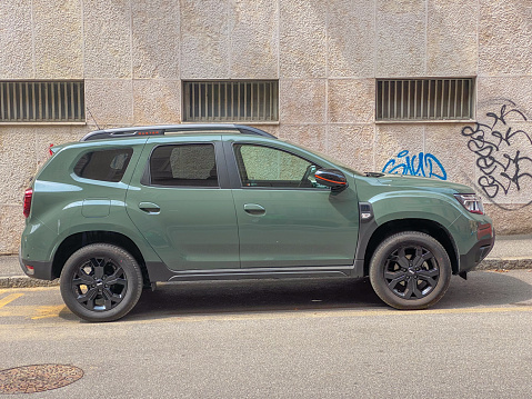 Castell'Arquato, Italy - June 25 2023 Jeep Dacia Duster in matte green new color parked in the street