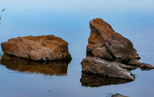 Coast with rocks in the water, Hadzhibey estuary. Reflection in water