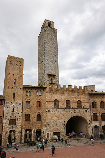 San Gimignano, Italy - Sept 17, 2022: Palazzo Vecchio del Podesta and the Rognosa Tower, also known as the Clock Tower or Podesta Tower in Piazza del Duomo in San Gimignano.