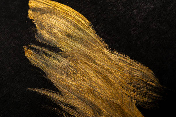 istock golden paint on black background 1972298706