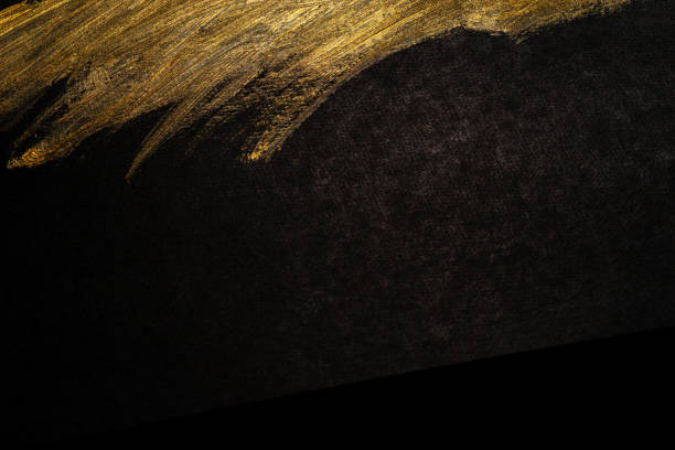istock golden paint on black background 1972299135