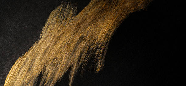 istock golden paint on black background 1972299227