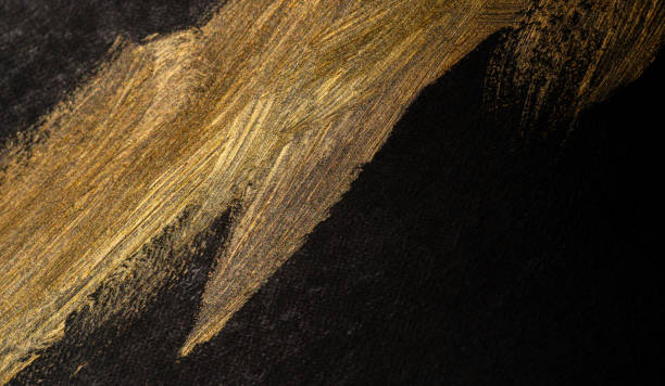 istock golden paint on black background 1972299259