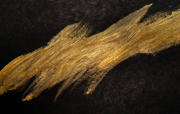 istock golden paint on black background 1972299766