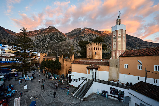 Place Outa El Hamam square with the Grand Mosque tower at sunset in Chefchaouen, Morocco, North Africa.
