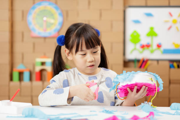 istock young girl making craft at home 1972321793