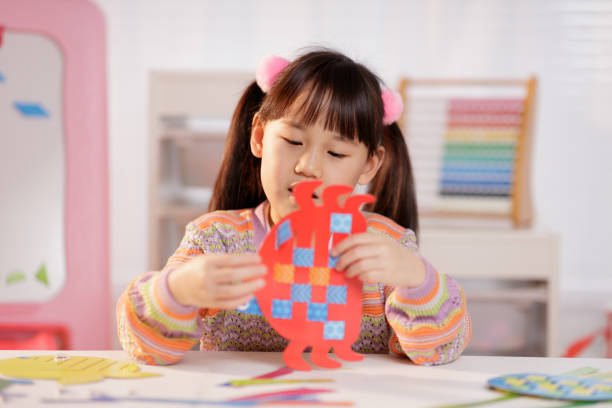 istock young girl making craft at home 1972322371
