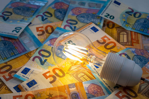 istock Light bulb on, on top of banknotes. 1972323521