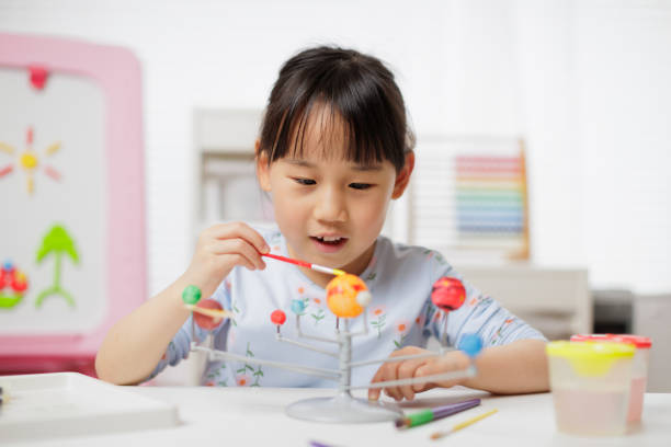istock young girl making craft at home 1972324047