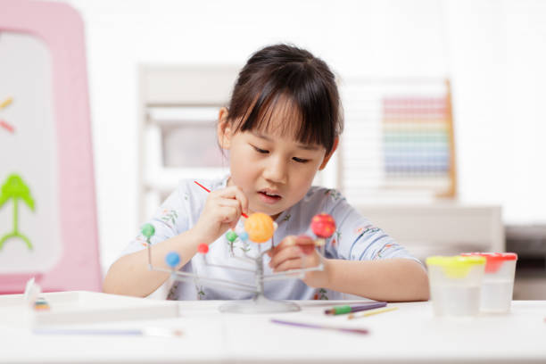 istock young girl making craft at home 1972324593