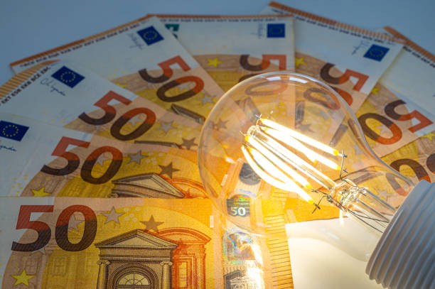 istock Light bulb on, on top of banknotes. 1972324614