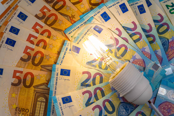 istock Light bulb on, on top of banknotes. 1972324617