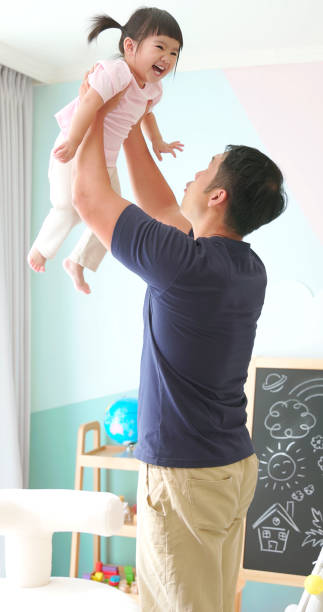 istock Asian father hold high kid 1972326760