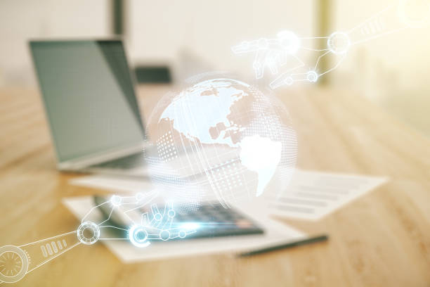 istock Double exposure of abstract virtual robotics technology with world map hologram on blurry calculator with laptop background. Research and development software concept 1972330495
