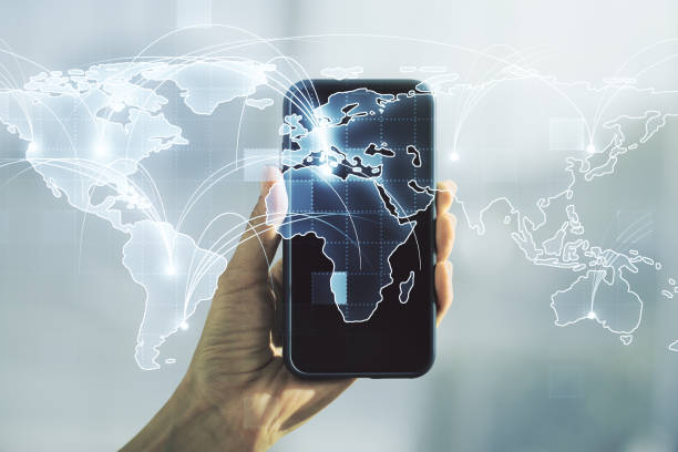 istock Abstract graphic digital world map with connections and hand with mobile phone on background, globalization concept. Multiexposure 1972331057