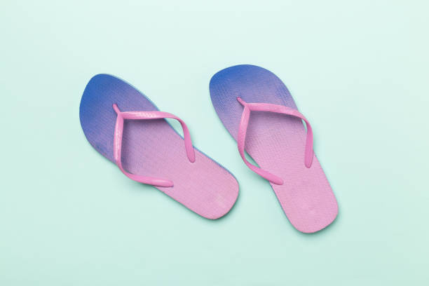 istock Bright flip flops on color background, top view 1972371846