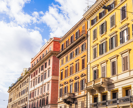 A series of apartment buildings along a street in central Rome.