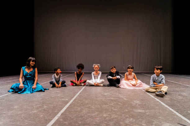 istock Child actors sitting on ground at stage theater 1972384220