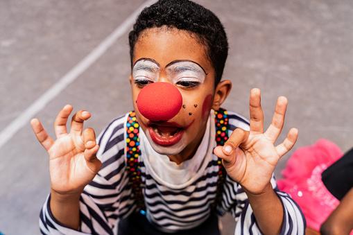 Child clown boy rehearsing to performance at stage theater