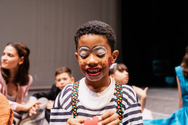 Child clown boy preparing to performance at stage theater