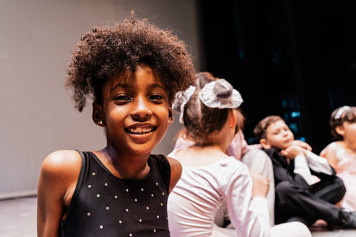 Portrait of a child ballerina at stage theater