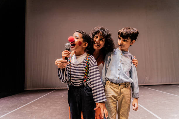 istock Child clown boy making jokes during presentation on stage theater 1972389123