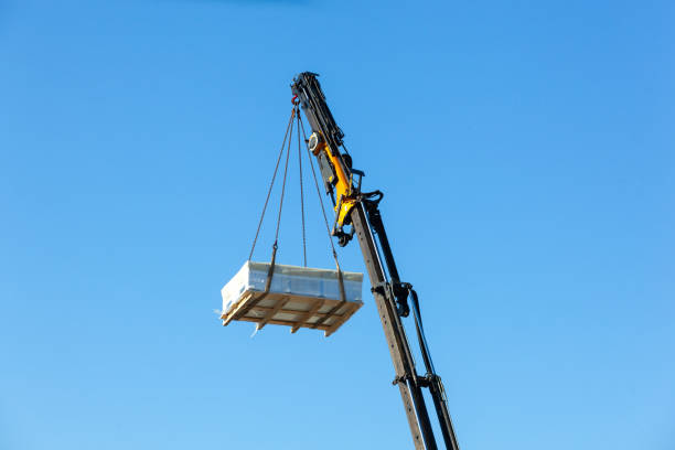 istock Crane moves large electrical component for radio wave repeater 1972397066