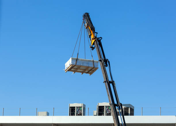 istock Crane moves large electrical component for radio wave repeater 1972398637